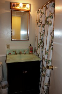 Here's what our guest bathroom looked like before we updated the faucet, medicine cabinet, and lights